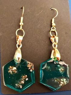 the earrings are green with gold flakes