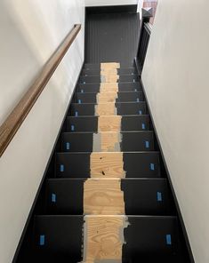 the stairs are painted black and have blue tape on them