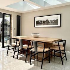 a dining table with four chairs and a bowl on it