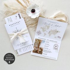 the wedding stationery is laid out on top of each other, with a white flower