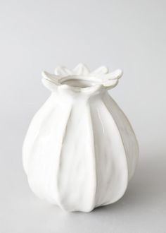 a white vase sitting on top of a table