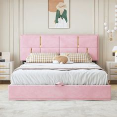 a pink bed in a bedroom with white walls and flooring, along with a teddy bear sitting on the footboard