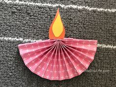 a pink paper fan with a flame on it