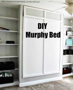 a bedroom with white bookcases and black lettering on the wall that says diy murphyby bed