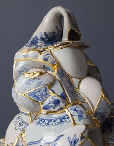 a blue and white vase sitting on top of a table