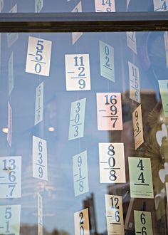 a store window with numbers and times on it's glass display windows are covered in sticky notes