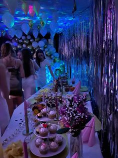 a long table filled with lots of desserts and cupcakes on top of it