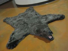 a stuffed bear laying on the floor with its mouth open