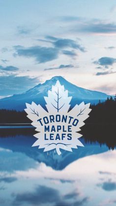 the toronto maple leafs logo is shown in front of a lake with mountains and trees