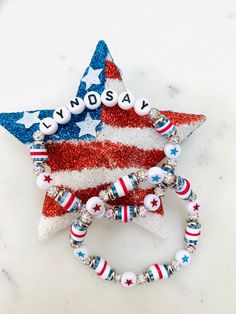 a red, white and blue beaded bracelet with an american flag star on it