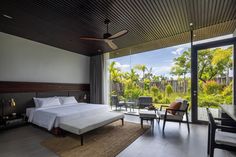 a bedroom with a large bed sitting next to a window