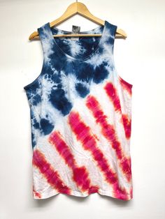 an american flag tie dye tank top hanging on a hanger