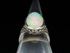 We've created this unique sterling silver ring to hold one of our luscious Ethiopian opals. Bright pink, soft blue, and lime green sparkles make for an outstanding ring! Metal: Sterling SilverGem: Ethiopian OpalGem Measurements: 16.0 x 10.0 mm, Oval Ring Size: 7.25Marks: "925" Stamped on the inside band Oval Ring, Oval Rings, Ring Metal, Ring Size 7, Ethiopian Opal, Bright Pink, Sterling Silver Ring, Lime Green, Silver Ring