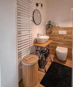 a modern bathroom with wooden floors and white walls