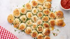 small appetizers are arranged in the shape of a heart on a table with a red and white checkered cloth