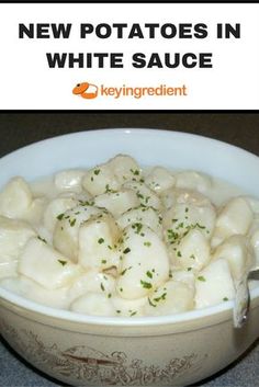 a white bowl filled with potatoes and garnished with parsley on top, next to the words new potatoes in white sauce