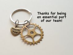 a keychain with a thank you tag attached to it that says, thanks for being an essential part of our team