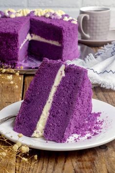 a purple cake with white frosting on a plate