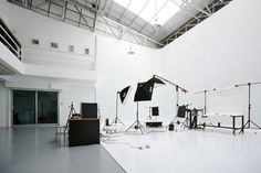 an empty room with several lighting equipment on the floor and in front of it is a white wall