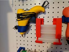 there are some toys on the pegboard and one has a hair dryer attached to it