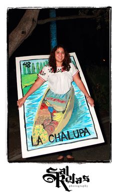 a woman standing in front of a poster with the words la chalura on it