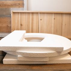 a white sculpture sitting on top of a wooden table