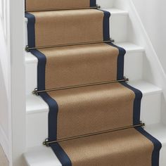 a set of stairs with blue and beige carpet