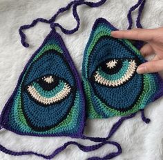 a crocheted triangle with an eye on it