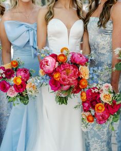 the bridesmaids are holding their bouquets in blue and pink colors with orange flowers