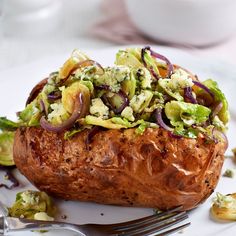 a close up of a baked potato on a plate