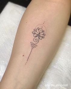 a woman's arm with a tattoo on it and a flower in the middle