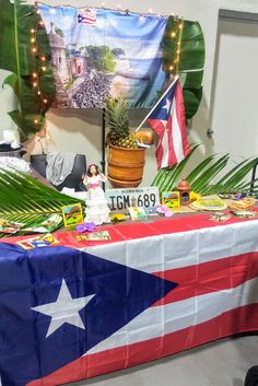 a table covered in decorations and flags with a flag draped over the table behind it