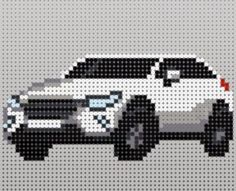 a cross stitch car is shown in white and black