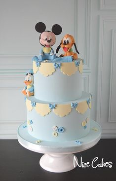 a mickey and minnie mouse cake with blue frosting