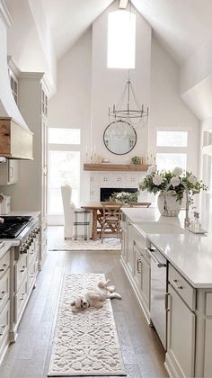 a kitchen with white cabinets and an area rug on the floor