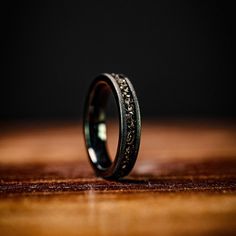 a wedding band that is on top of a wooden table