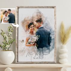 a wedding photo is displayed on a shelf next to a vase with flowers in it