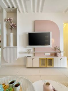 a living room filled with furniture and a flat screen tv on top of a wall