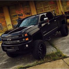 a black truck parked in front of a building