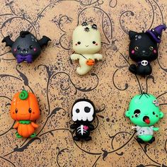 there are six little halloween monsters on the table