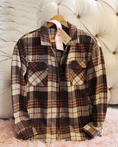 The softest sweet flannel for the season. Rich brown & rust tones pair with a button up front & cute pockets. Easy fit & perfect as is or layered. Color: Brown, cream & rust Soft poly & cotton blend Hand wash cold Small Medium Large Bust 42 44 46 Waist 42 44 46 Hips 43 45 47 Length 28 28 28 Bust, waist, and hip measurements are a total circumference. Length is measured from the top of the shirt to the hem. Measurements are an estimate. Cheap Vintage Winter Flannel Shirt, Cheap Vintage Flannel Shirt With Buttons, Brown Long Sleeve Flannel Shirt For Winter, Winter Brown Long Sleeve Flannel Shirt, Casual Brown Winter Shirt, Brown Button-up Flannel Shirt With Pockets, Brown Cotton Shirt For Winter, Classic Brown Button-up Flannel Shirt, Brown Button Closure Flannel Shirt