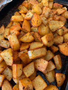 cooked potatoes in a pan with seasoning on top, ready to be served for dinner