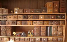 a wooden shelf filled with lots of books and figurines