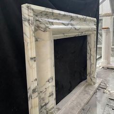 a white marble fireplace surround in a room