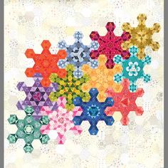 a colorful quilt with many different colored snowflakes