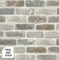 an old brick wall with grey and brown bricks