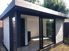 a small house with sliding glass doors on the outside