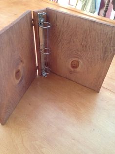 an open wooden binder sitting on top of a table