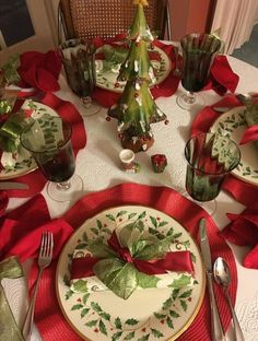 a table set for christmas with plates and silverware