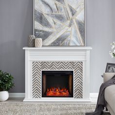 a living room with a white fireplace and gray walls in front of a painting on the wall